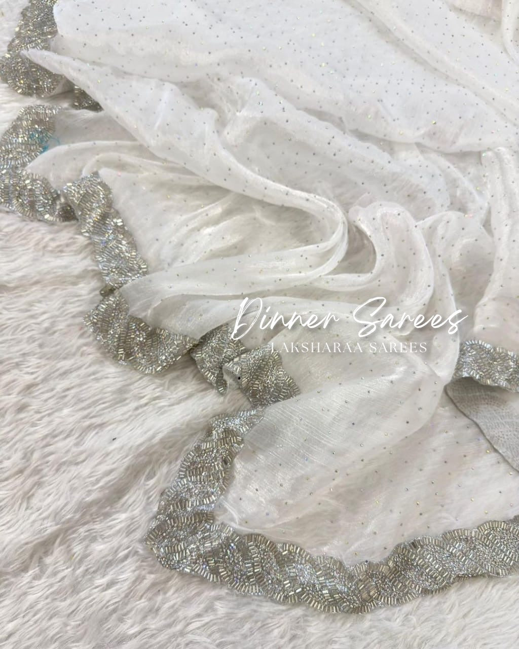 Luxe shimmer silk saree with silver jarkan border from Laksharaa Sarees, featuring elegant draping and intricate embellishments.
