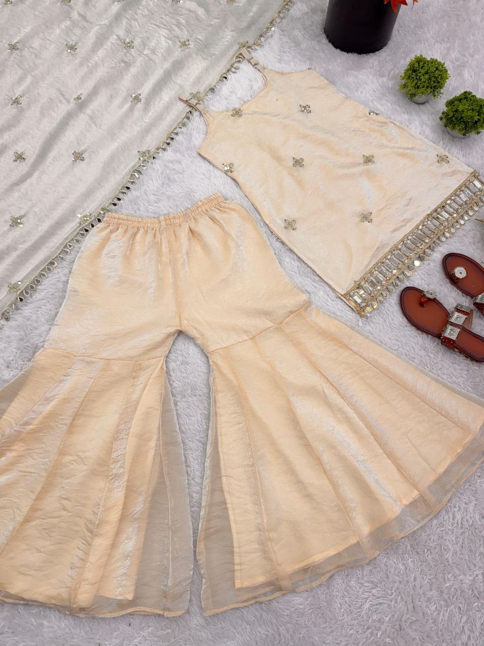 Shimmer silk sharara set by Laksharaa Sarees, featuring intricate embroidery and flowing fabric in a traditional Indian style.