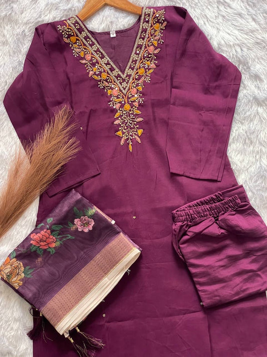 Purple embroidered outfit with a scarf on a purple gray background