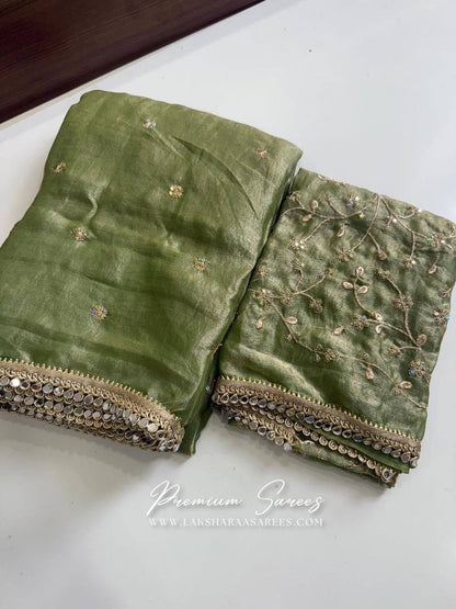 Elegant SWARNI shimmer satin saree paired with an embroidered blouse, showcasing intricate detailing in soft, luxurious fabric.