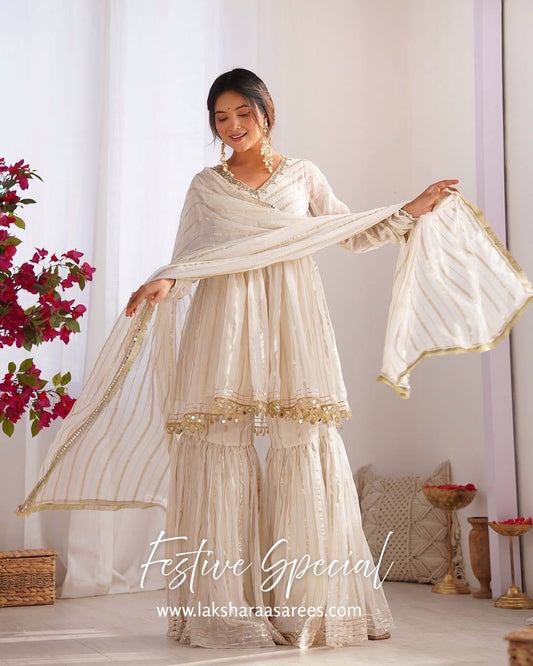 White Chanderi peplum style Sharara suit with intricate embroidery, designed by Laksharaa Sarees, displayed on a hanger.