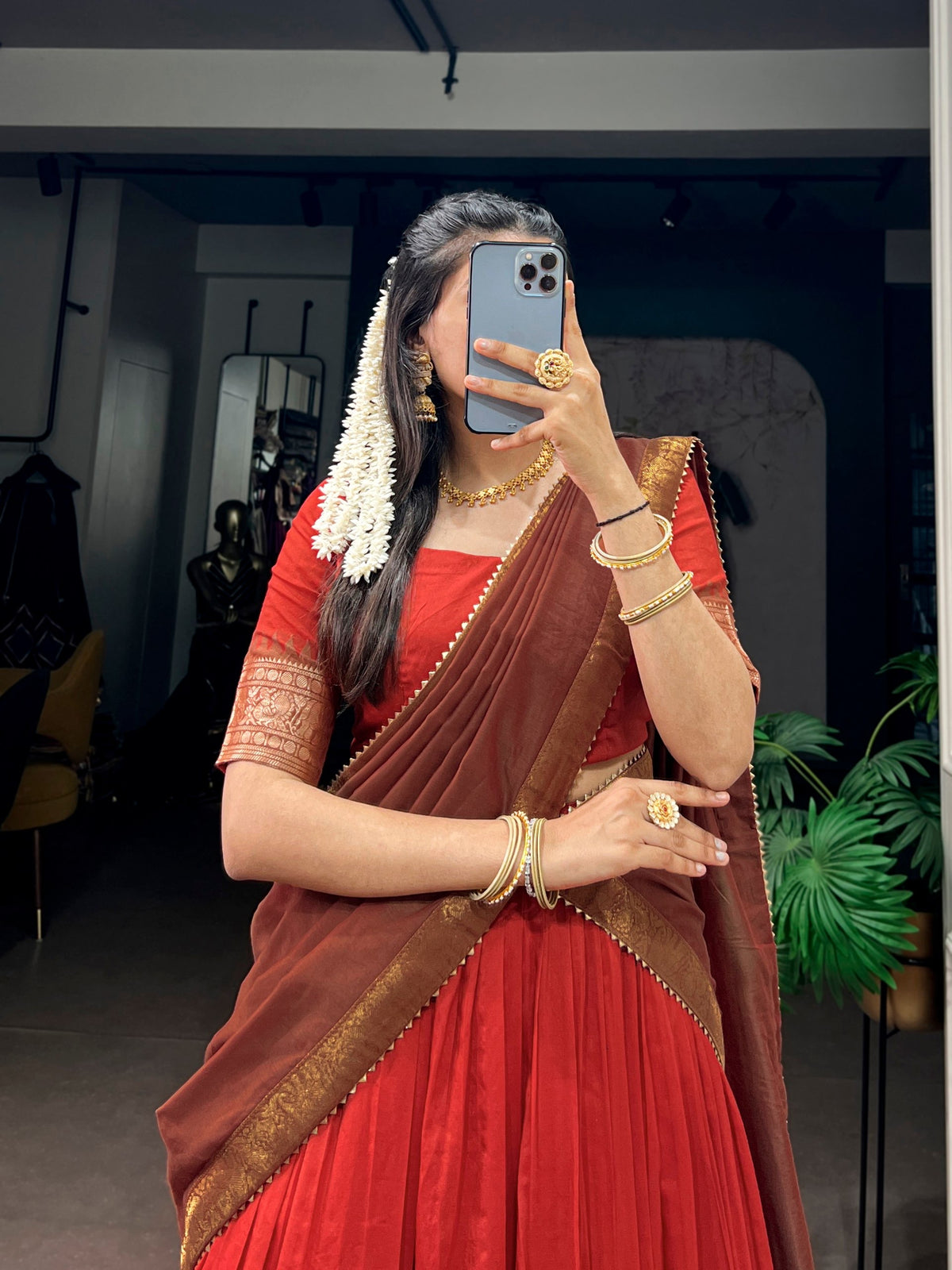 South Indian-style half saree lehenga by Laksharaa Sarees, featuring intricate embroidery and vibrant silk fabric.