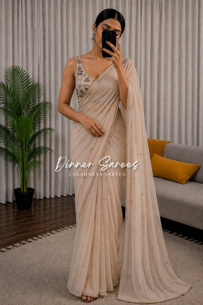 Soft pink georgette dinner saree with floral bloom designs from Laksharaa Sarees, featuring elegant drape and intricate detailing.