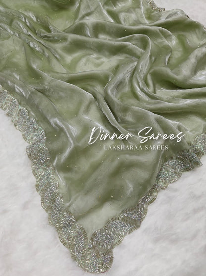 Luxe shimmer silk saree by Laksharaa Sarees featuring a silver Jarkan border and elegant drape.