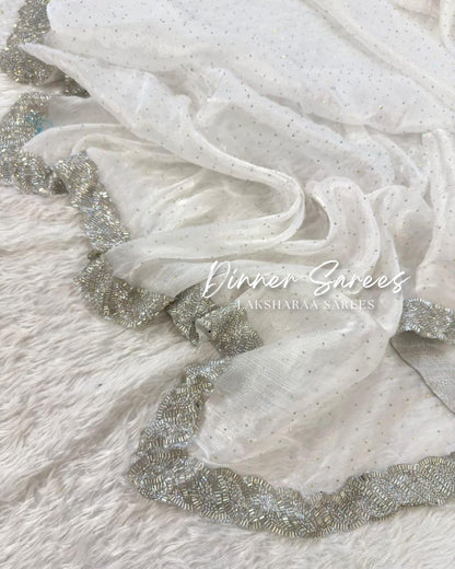 Luxe shimmer silk saree with silver jarkan border from Laksharaa Sarees, featuring elegant draping and intricate embellishments.