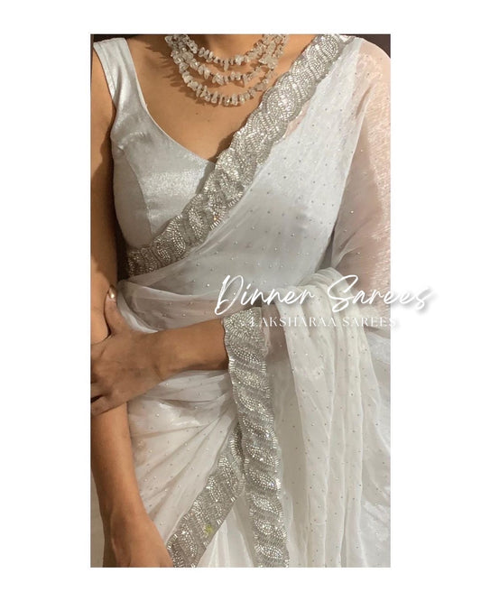 Luxe shimmer silk saree with silver jarkan border from Laksharaa Sarees, showcasing elegant drape and intricate silver embroidery.