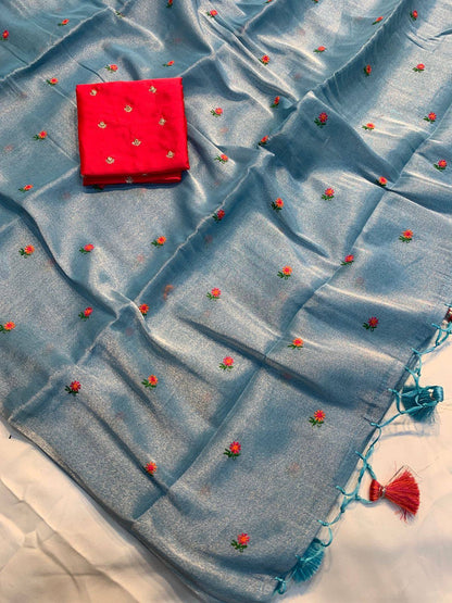 Soft simmer tissue linen saree by Laksharaa Sarees featuring intricate embroidery and elegant drape in pastel shades.