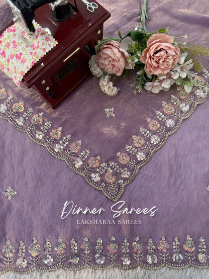 Elegant georgette dinner saree with embroidered border by Laksharaa Sarees, featuring intricate craftsmanship and rich fabric details.