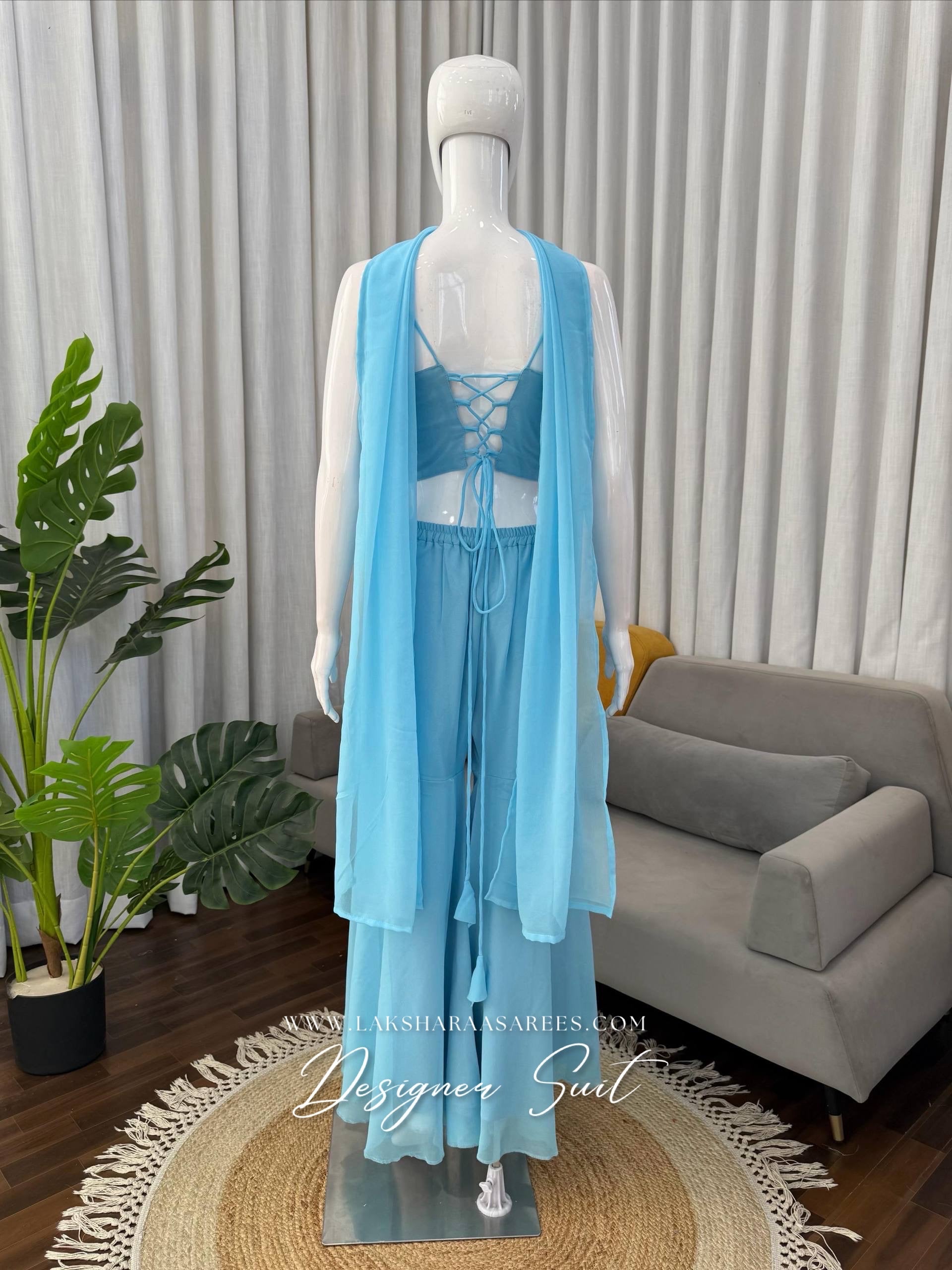 Elegant ISHITA 90s Special Georgette Corset Suit by Laksharaa Sarees, showcasing intricate design and flowing fabric details.