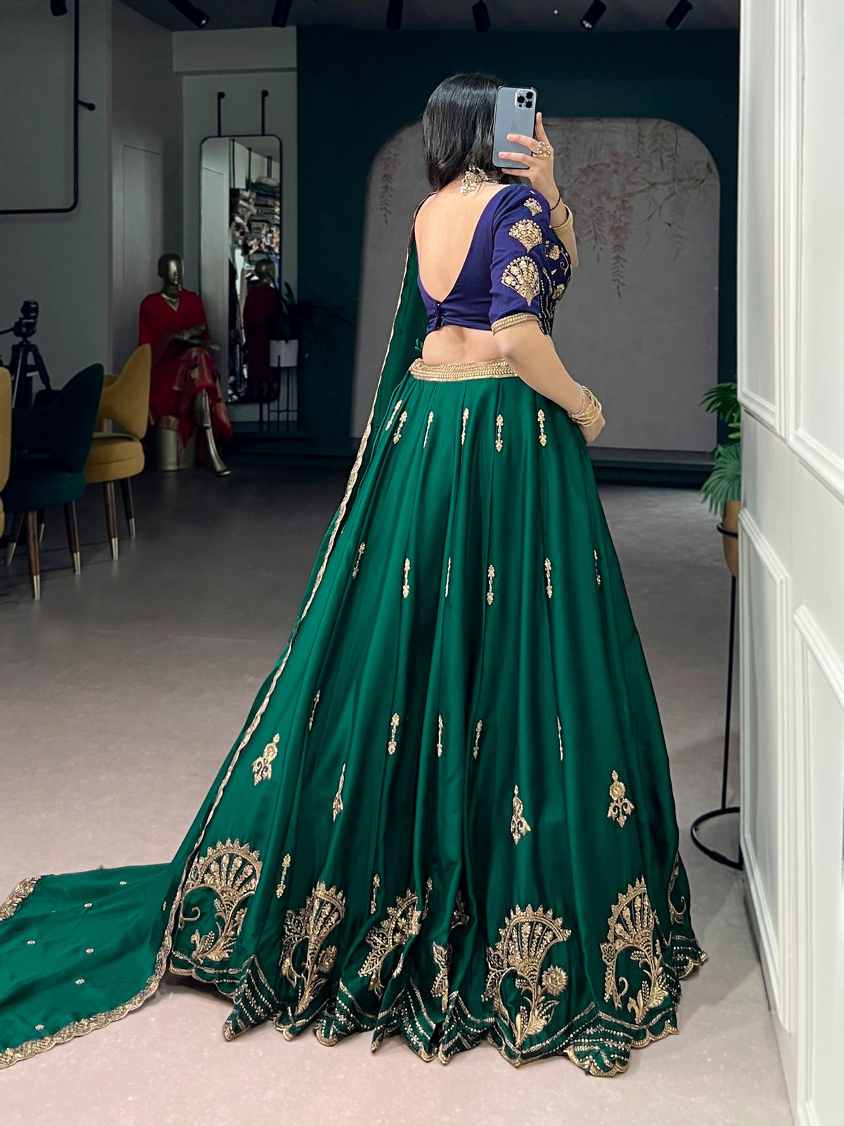 Green and blue Rangoli silk lehenga by Laksharaa Sarees featuring intricate embroidery and vibrant traditional design.