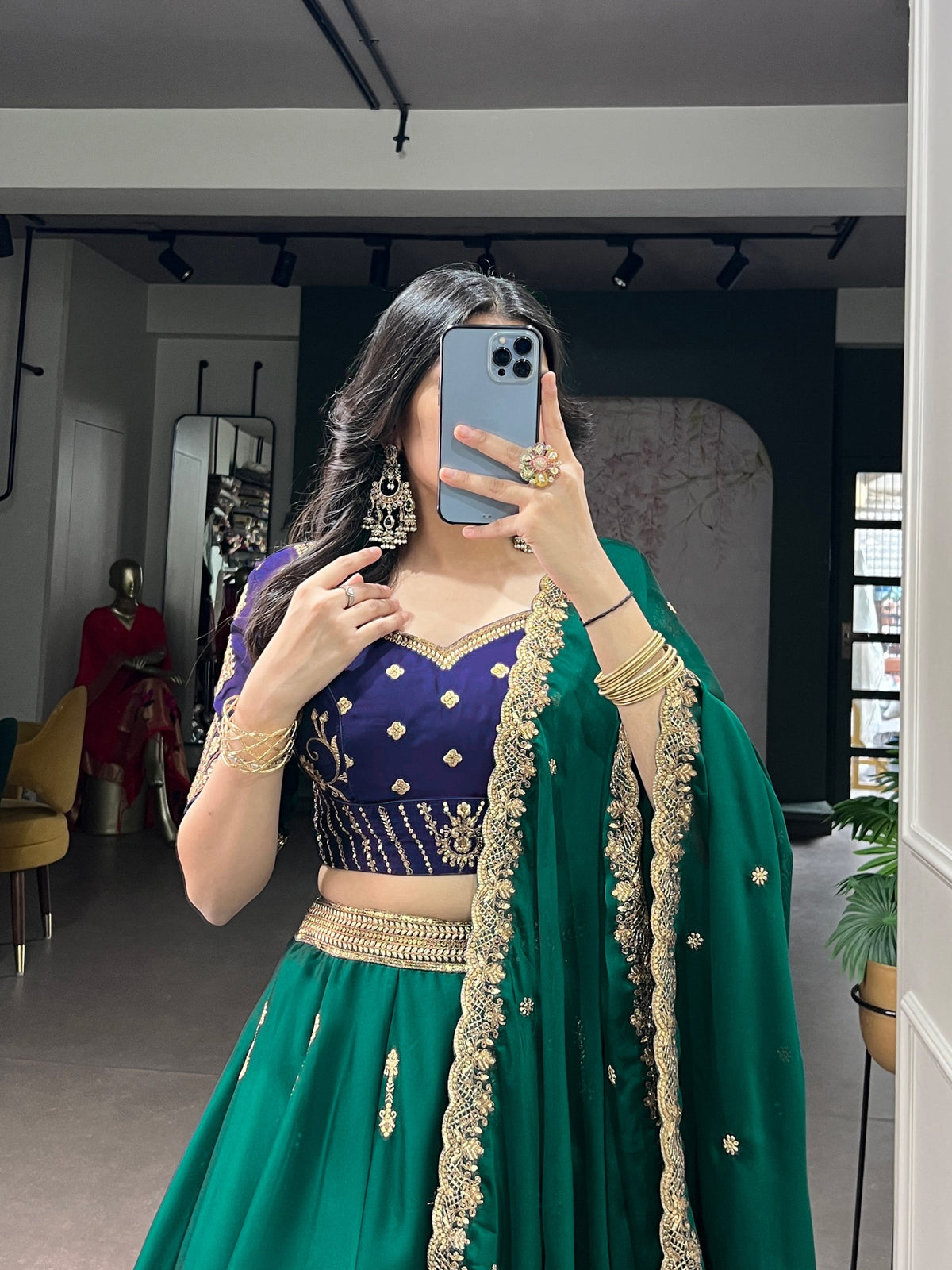 Green and blue Rangoli silk Lehenga by Laksharaa Sarees, featuring intricate embroidery and traditional design.
