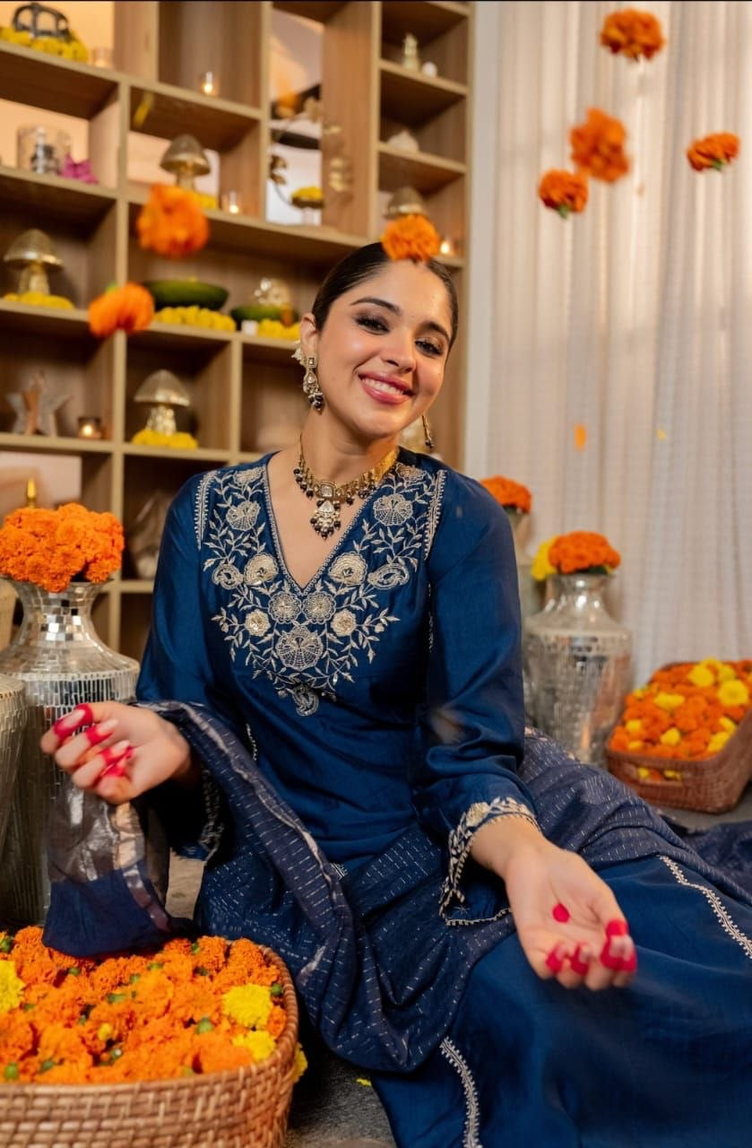 Laksharaa Sarees Kurtis displayed on a hanger, showcasing vibrant traditional design and colorful fabric details.