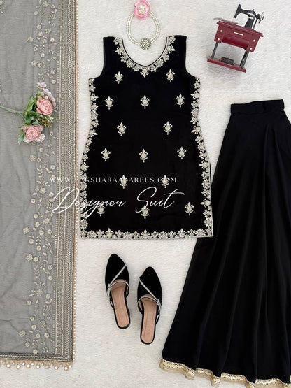 Black georgette palazzo suit by Laksharaa Sarees featuring intricate embroidery and flowing fabric, shown from a front view.