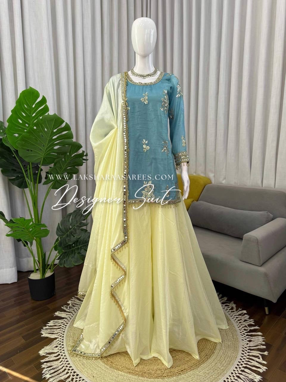 Blue and yellow shimmer silk designer suit with intricate patterns from Laksharaa Sarees, featuring elegant traditional embroidery.