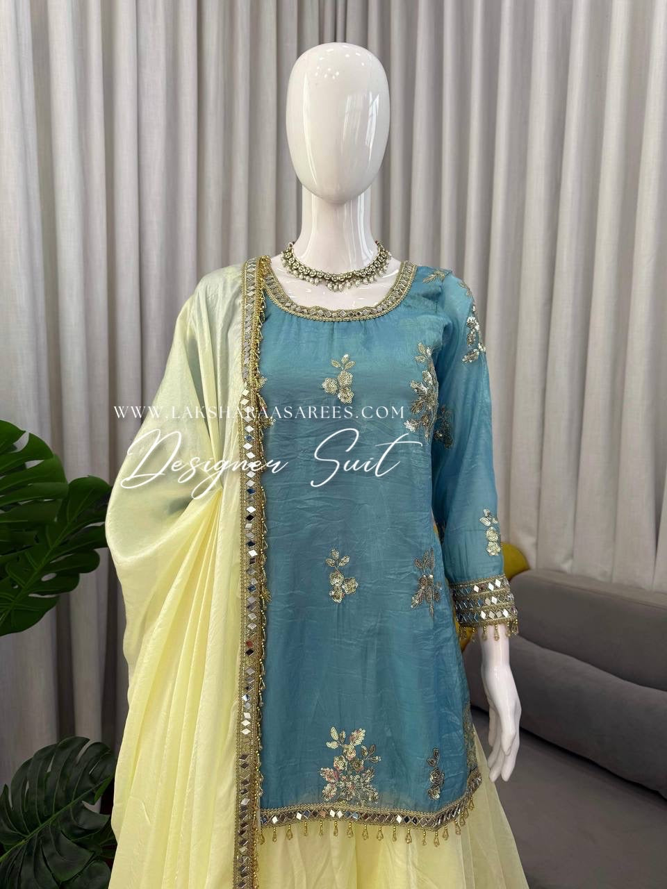 Blue and yellow shimmer silk designer suit from Laksharaa Sarees with intricate embroidery and elegant detailing.