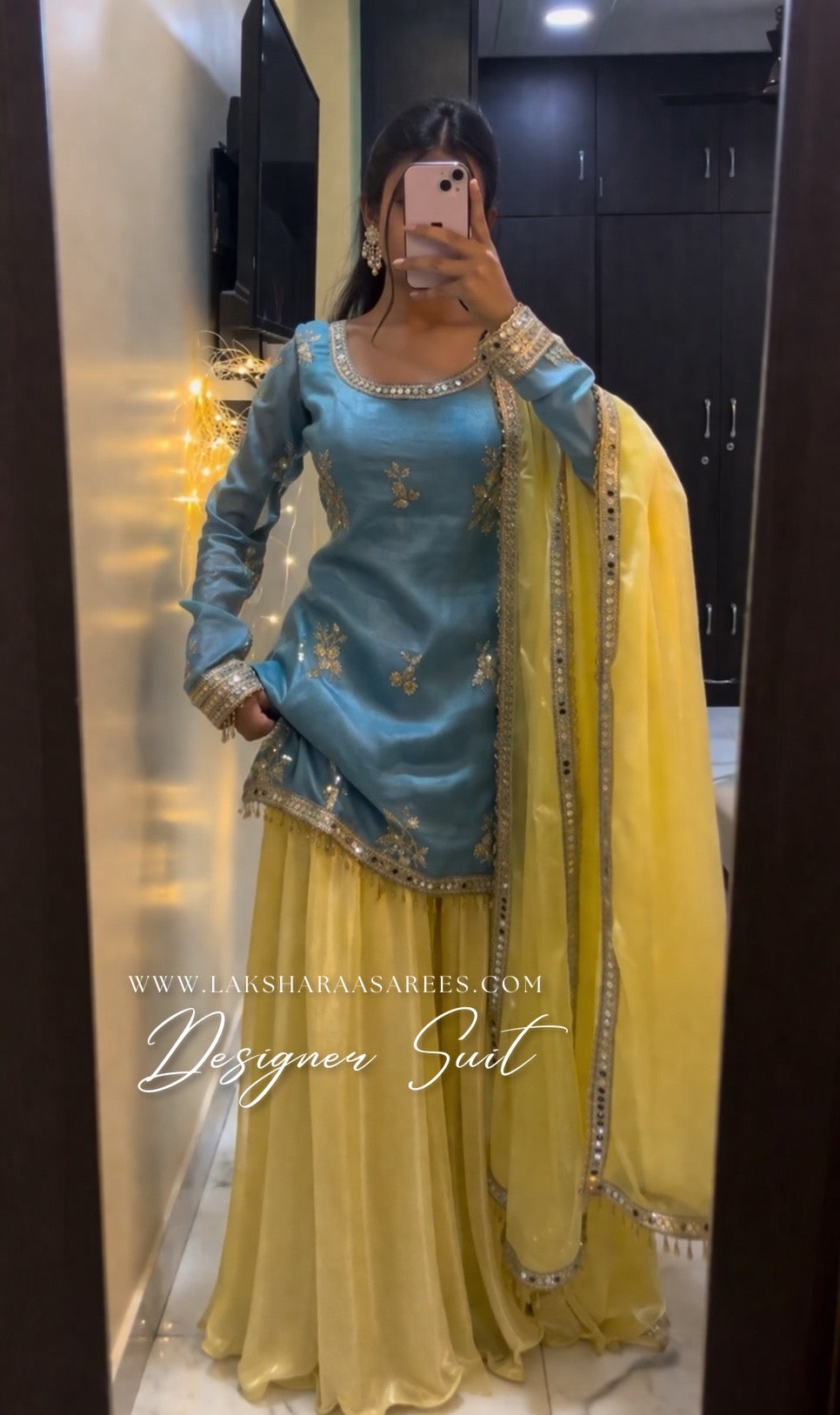 Blue and yellow shimmer silk designer suit by Laksharaa Sarees, featuring intricate embroidery and elegant traditional styling.