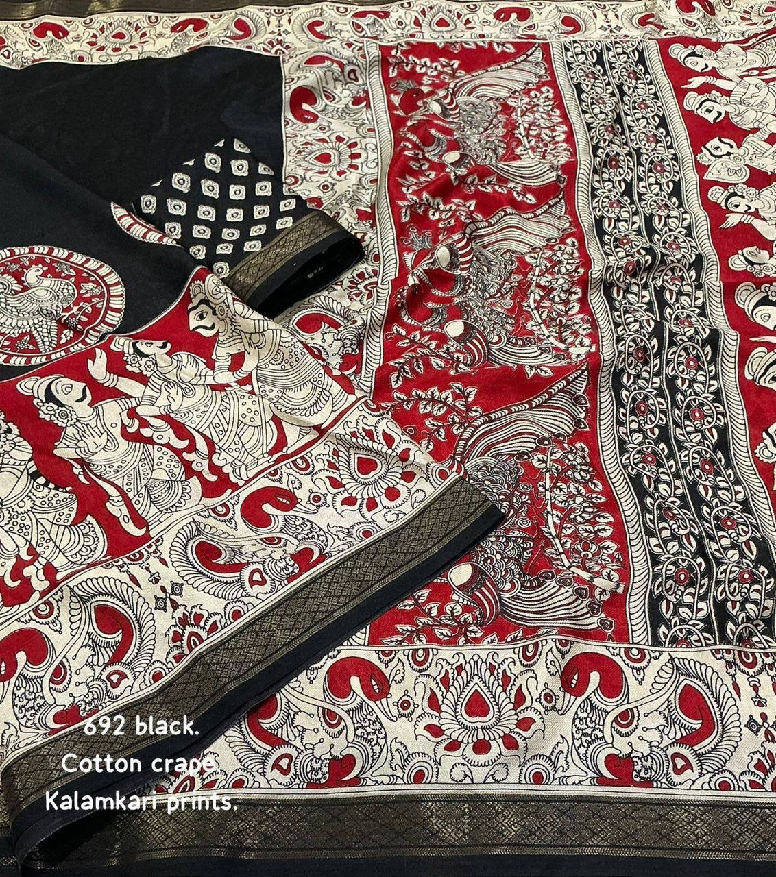 Black and red soft cotton crepe Kalamkari saree with intricate designs, displayed on a hanger showing its elegant drape.