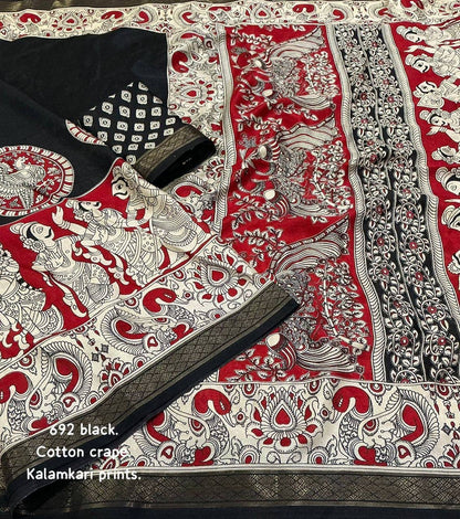 Black and red soft cotton crepe Kalamkari saree with intricate designs, displayed on a hanger showing its elegant drape.