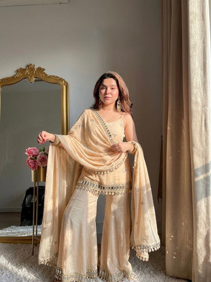 Mehreen shimmer silk sharara suit set with intricate detailing, featuring a matching top and wide-legged sharara pants.