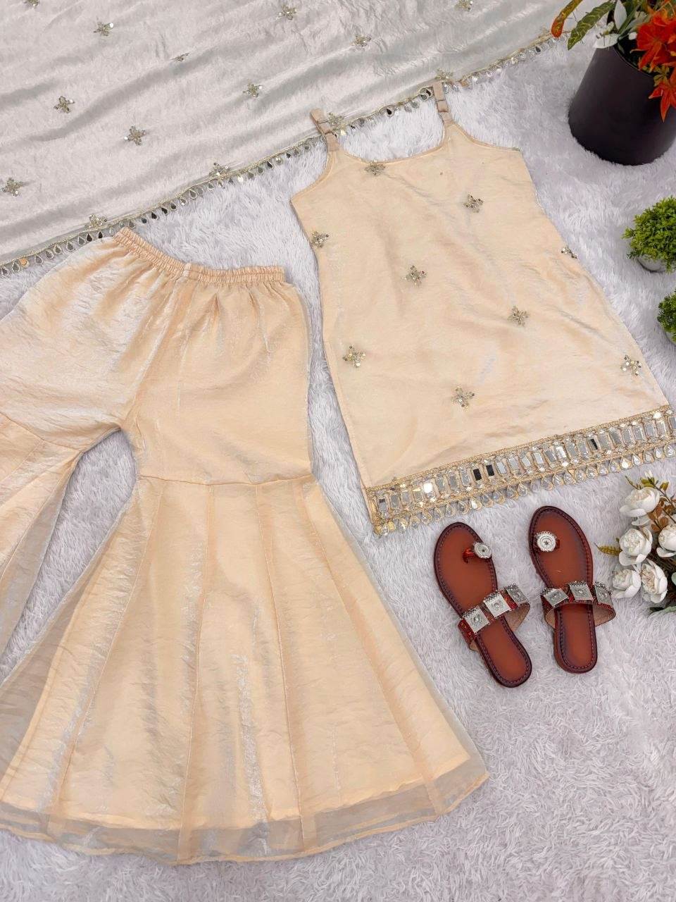 Shimmer silk sharara suit with intricate embroidery in a vibrant color, designed by Laksharaa Sarees, displayed on a hanger.