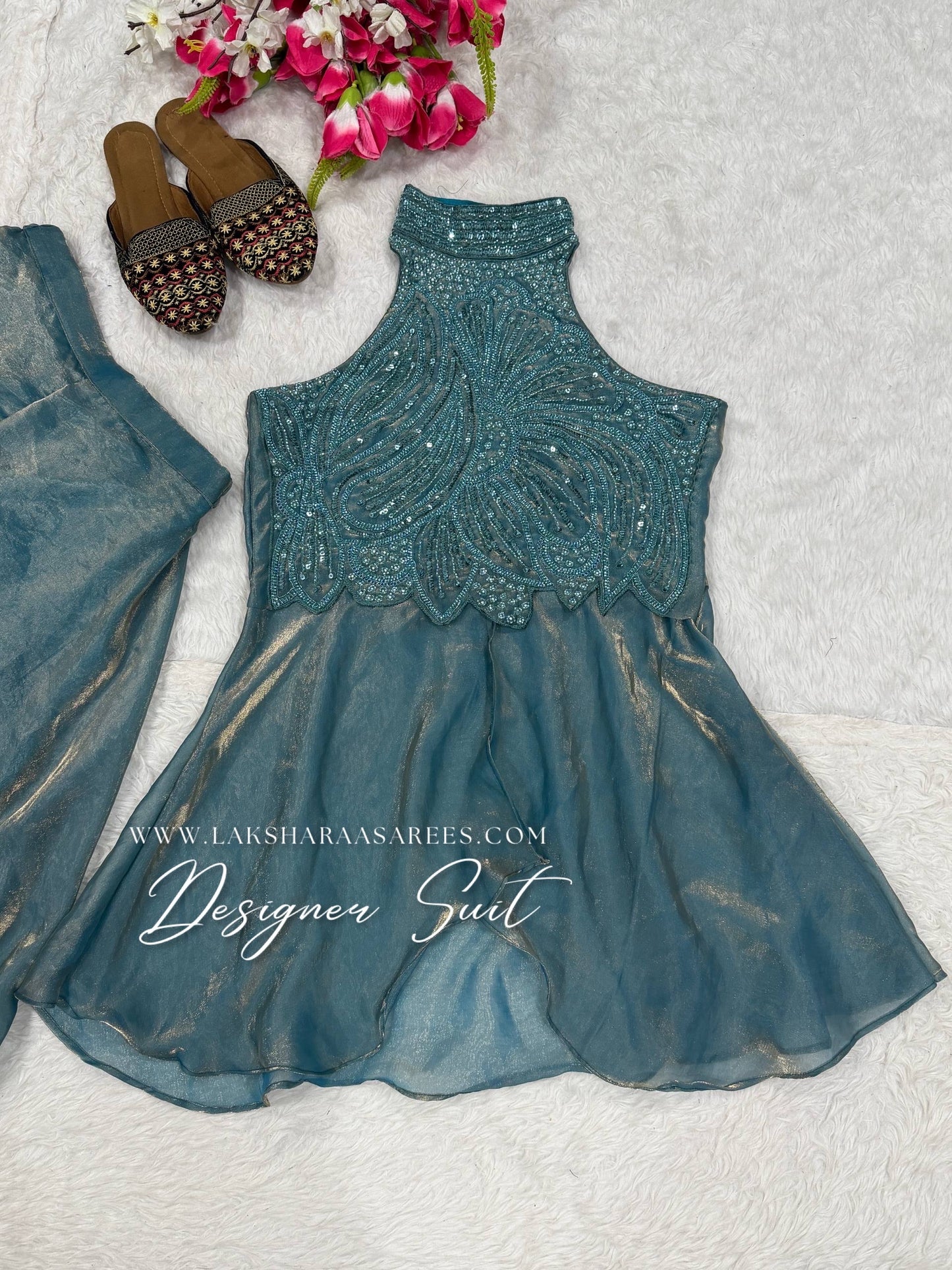 Shimmer silk halter top designer suit with matching palazzo pants by Laksharaa Sarees, showcasing intricate embroidery and elegant fabric.
