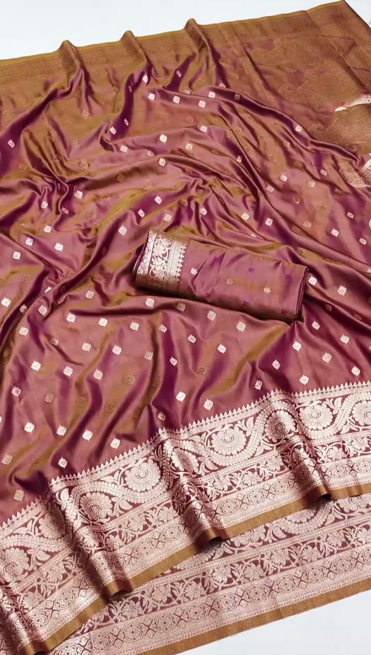 NILAA dual toned Banarasi soft silk saree in vibrant colors with intricate gold zari work, displayed on a hanger.