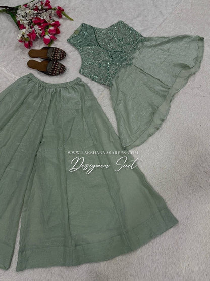 Shimmer silk halter top designer suit with matching palazzo pants by Laksharaa Sarees, shown with intricate detailing and elegant style.